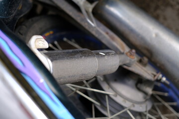 Close-up of the motorcycle rear shock cylinder.