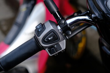 The handlebar switch on the left side of the motorcycle.