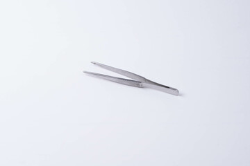 metal tweezers on a white background