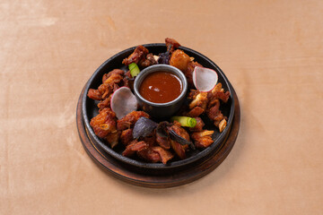 fried lamb ribs with salad and tomato sauce