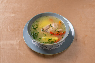 chicken soup with potatoes, vegetables and herbs