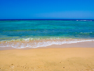 Beautiful wild beach with turquoise water, orange sand and coral reef. Egypt, Marsa alam. Red sea