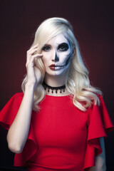 Beautiful girl in painted skull mask. Halloween Art make-up. Santa Muerte