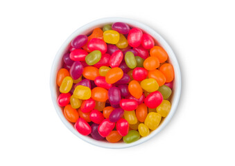 Various jelly beans sweet gummy candies in ceramic plate on white background.