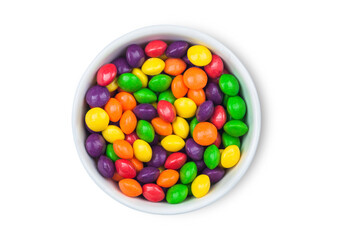 Multicolored fruit candies in plate on white background.