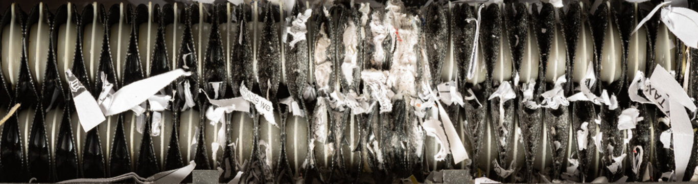 Close Up View Of Home Paper Shredder Teeth Jammed With Shredded Paper