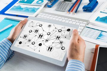 Men's hands hold a computer tablet