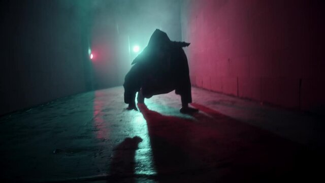 Demon with horns crawling in corridor. Silhouette of devil in darkness. Halloween, a traditional American holiday concept. Evil magician making rite or sacrifice during full moon, evil spirit, satan.