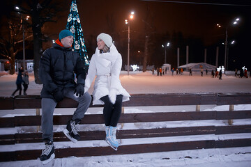 couple on ice rink evening, lovers christmas sport winter holidays