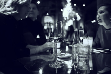 restaurant table view evening wine glass, friends at the party