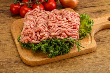 Raw pork minced meat over board