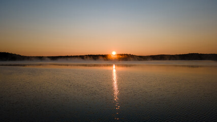 Beautful sunrise on a lake with fog  in Tiveden Nationalpark in Sweden - Drone Perspective Landscape Photography