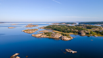 Swedish archipelago in Bohuslän with a blue sky in the background - Drone Perspective Landscape Photography - obrazy, fototapety, plakaty