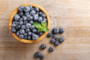 Freshly picked blueberries in a wooden bowl. Healthy berry, organic food, antioxidant, vitamin