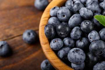 Freshly picked blueberries in a wooden bowl. Healthy berry, organic food, antioxidant, vitamin