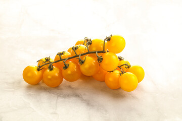 Branch with yellow cherry tomato