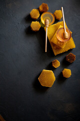 Healthy Thick honey dipping from the wooden honey spoon, bee products by organic natural...