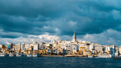 Beautiful dark clouds over Galata Tower old colorful houses Istanbul cityscape bosphorus sea