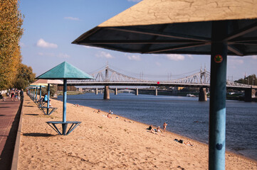 Summer beach in the city center with a view of the bridges