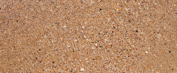 Beach sand texture on a summer day. Top view, flat lay. Banner