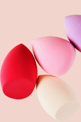 Bright cosmetic beauty sponges different form Red and pink colored makeup tools for tone cream, foundation, concealer.