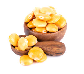 Pickled yellow lupine beans in wooden bowl and spoon, isolated on white background. Tournus, preserved lupinus.