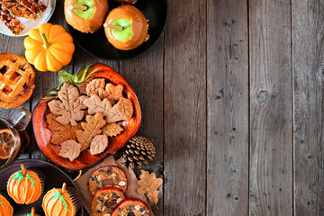 Autumn desserts side border. Table scene with a variety of sweet fall treats. Above view over a rustic wood background. Copy space.