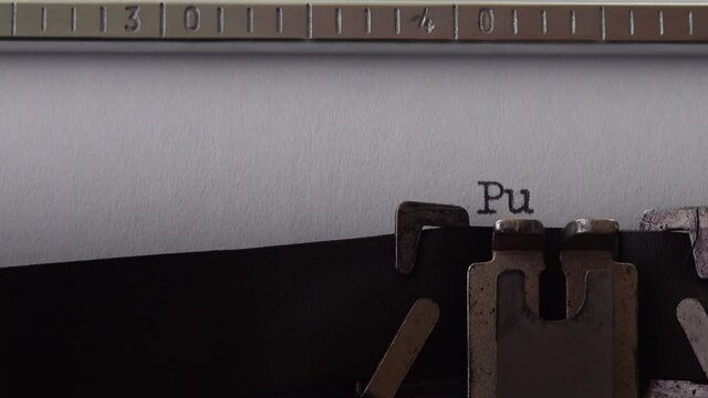 Typing phrase Pulp Fiction on retro typewriter. Close up.