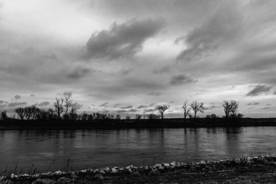 sunrise behind clouds over river