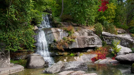 Poster de jardin Paysages stone mountain waterfall and lake. A picturesque cascade waterfall among large stones in the Landscape Park, in spring or summer. big waterfalls, nature. Europe, Ukraine, Uman, Sofiyivka arboretum  © Oleksandr Filatov