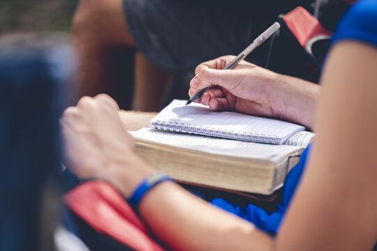 Christianperson taking notes at a religious ceremony in a church