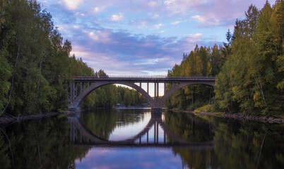 Fototapeta na wymiar Old Finnish arch bridge on the Janisjoki river in Karelia