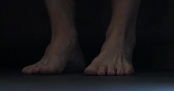 Slow motion man put his feet on floor early morning and massage them