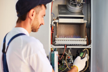 The master engineer maintains the gas heater. Adjusts the combustion of gas in the equipment