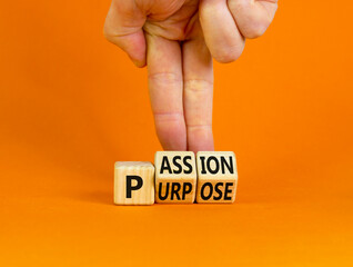 Passion or purpose symbol. Businessman turns wooden cubes and changes the concept word 'purpose' to...