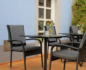 table with chairs outside a restaurant area in London no people stock photo