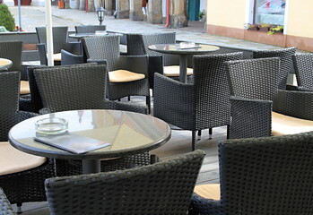 table with chairs outside a restaurant area in London no people stock photo