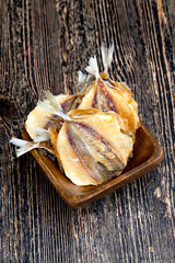 dried and butchered small fish on a wooden table