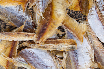 dried and butchered small fish on a wooden table