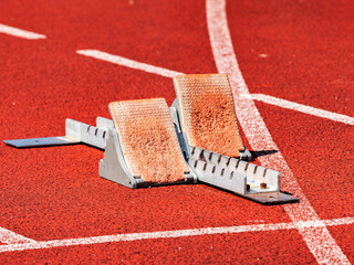 Side view of worn out starting blocks on running tracks