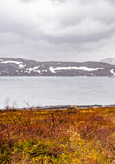 Fototapeta na wymiar Vavatn lake panorama rough landscape snowed-in mountains Hemsedal Norway.