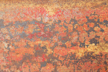 Rusty metal background with cracked paint. Orange textured surface.