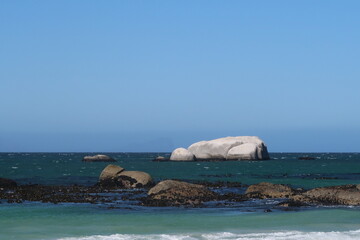Fototapeta premium Scenic turquoise ocean water with large granite boulders, Cape Town, South africa, Concept of travel, South Africa, Cape town, retirement, holiday, vacation, relaxation. Calming rhythms.