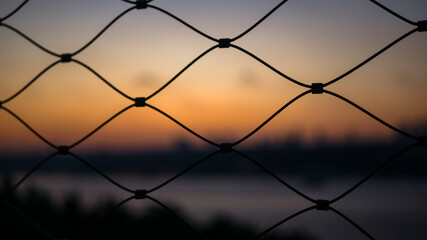 Beautiful Istanbul sunset golden hour through fence cage selective focus 