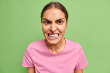 Portrait of angry European woman frowns face clenches teeth has furious expression irritates...