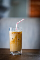 Frozen late with layers of espresso coffee and milk substitute in a glass with a straw