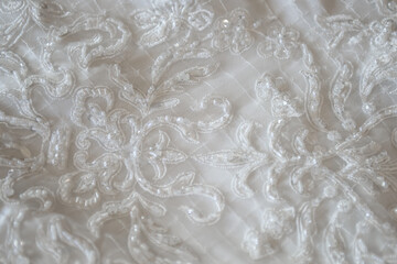 Background of the lace white dress of the bride. The bride's wedding clothes are waiting for the ceremony.