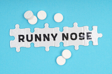 On a blue background pills and puzzles with the inscription - Runny Nose