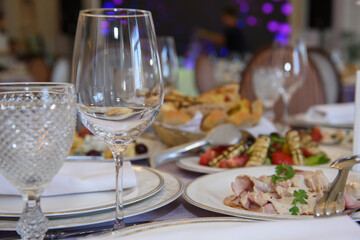 A table with food dishes in the restaurant. Festive food in the reception room.