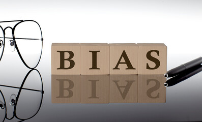 Close-up Of BIAS Wooden Blocks on the black background with glasses and pen